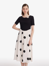 a lady in a silk polka dots printed drop waist midi dress